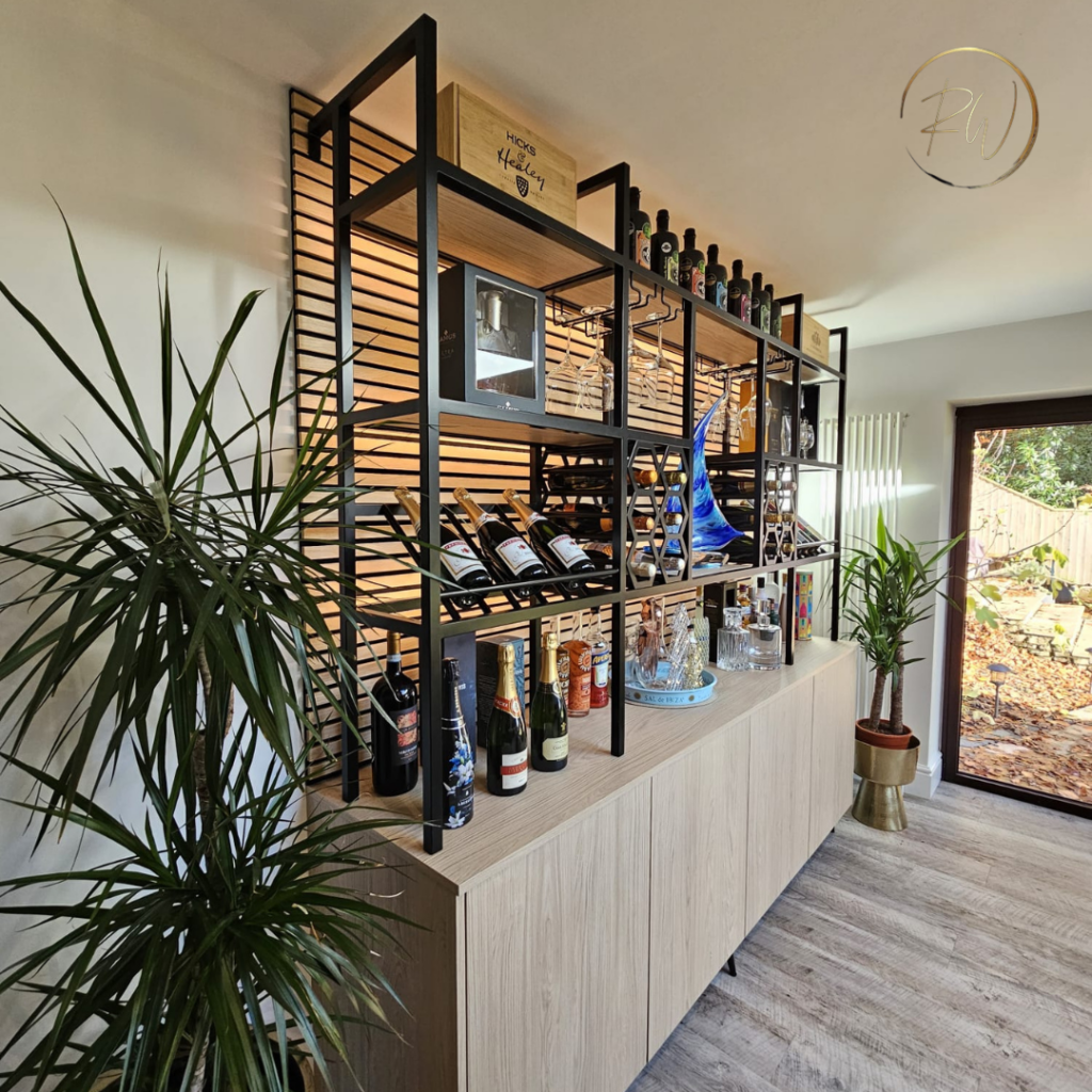 Custom oak bar and wine storage unit with black metal framework, integrated shelving, wine racks and concealed storage cabinetry in Broadstone.